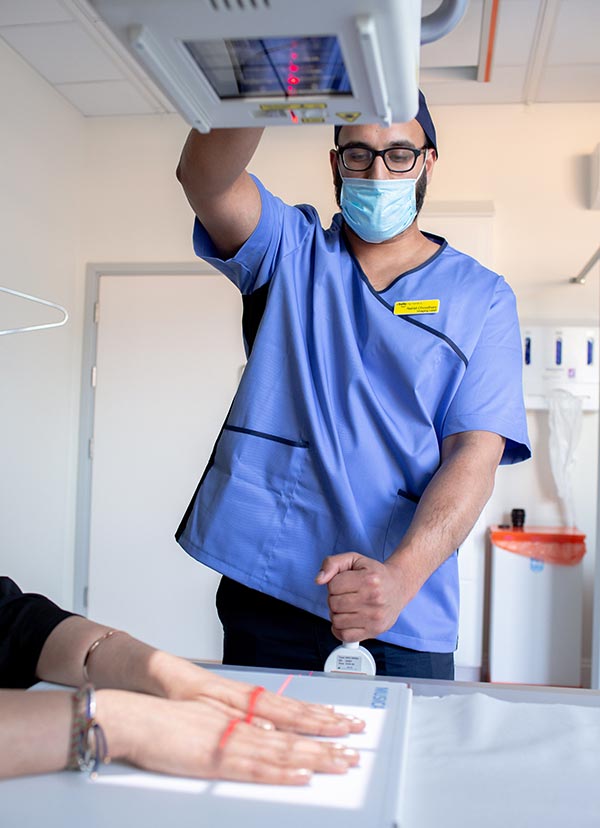 Man taking xray of woman's hands