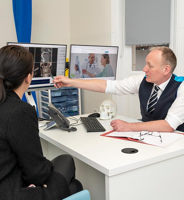 Consultant with patient showing xray