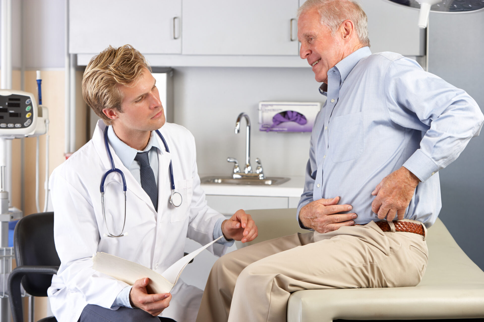 Doctor Examining Male Patient With Hip Pain