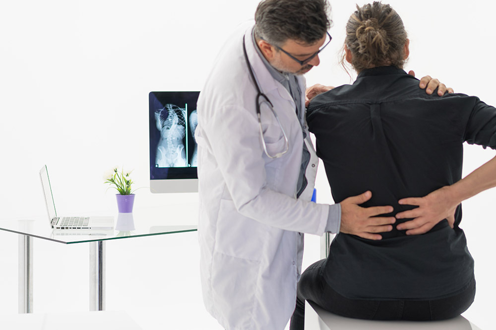 doctor examining a patient with back pain