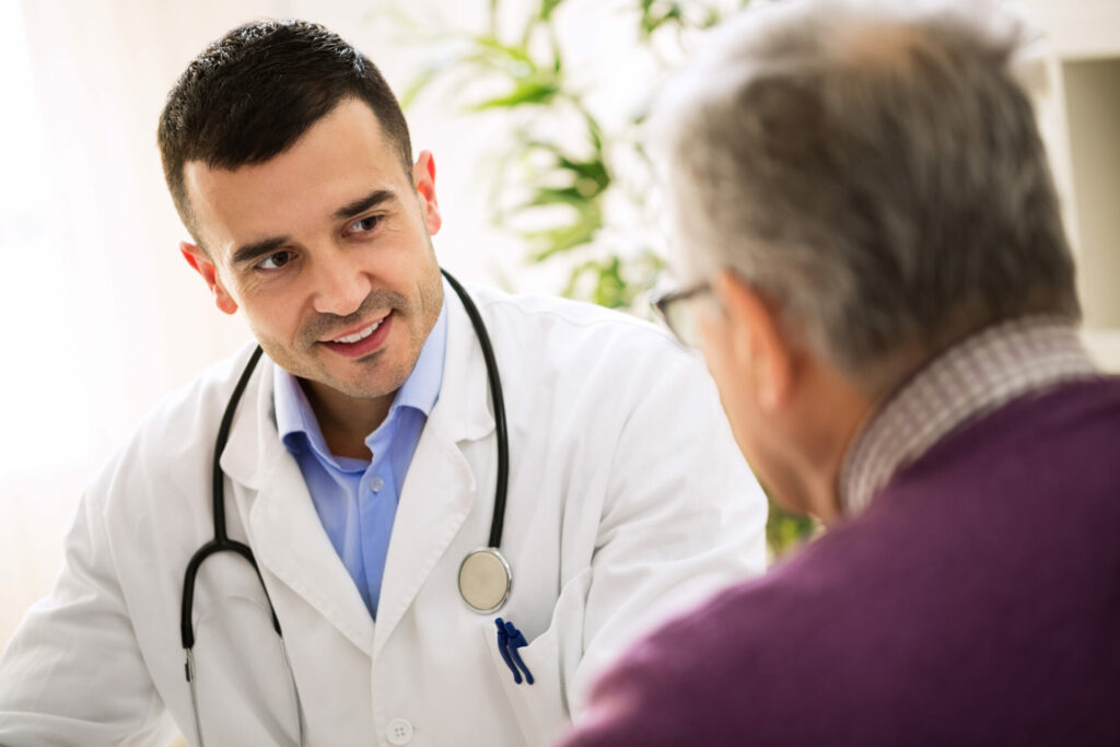 elderly man consulting with a doctor