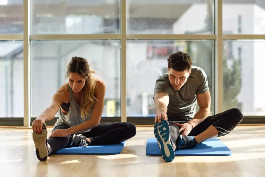 man and woman stretching