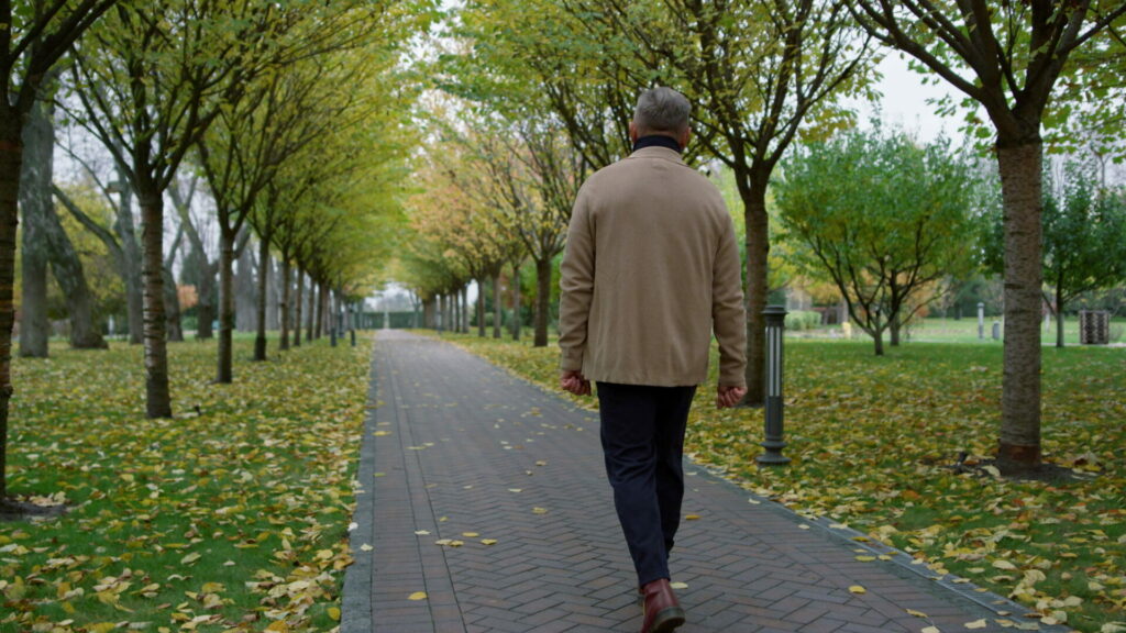 older man walking in the park