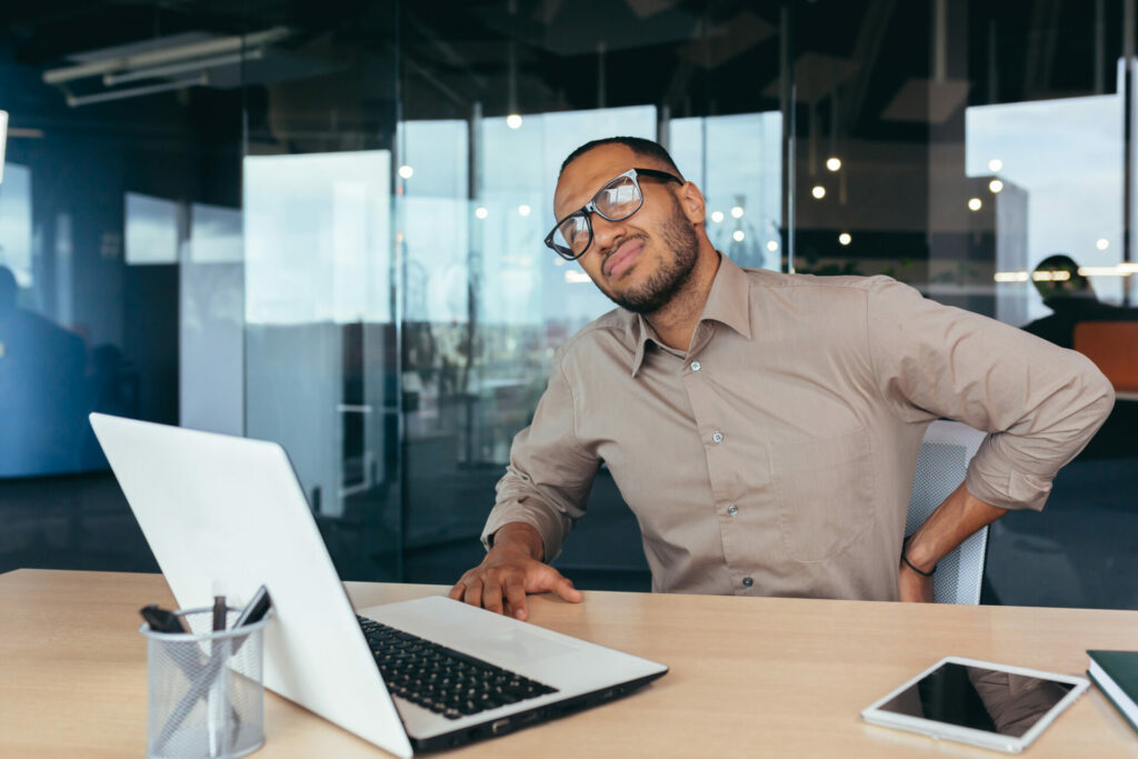 worker suffering from back pain at the office