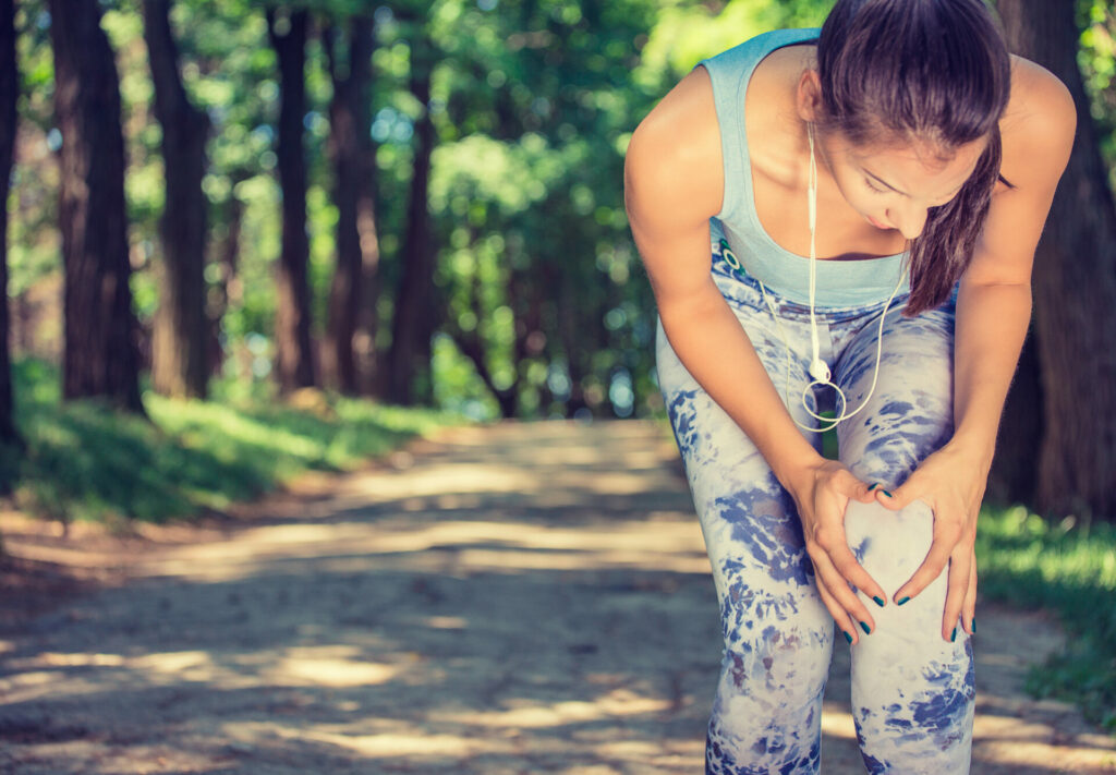 female jogger suffering from knee pain