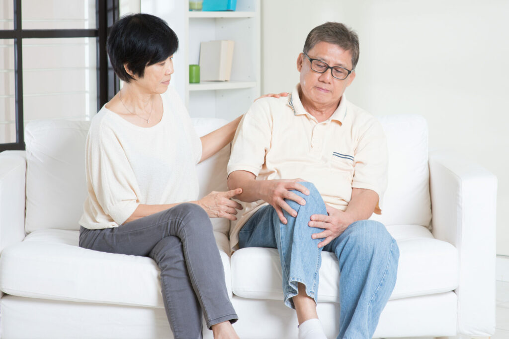 wife comforts husband with knee pain