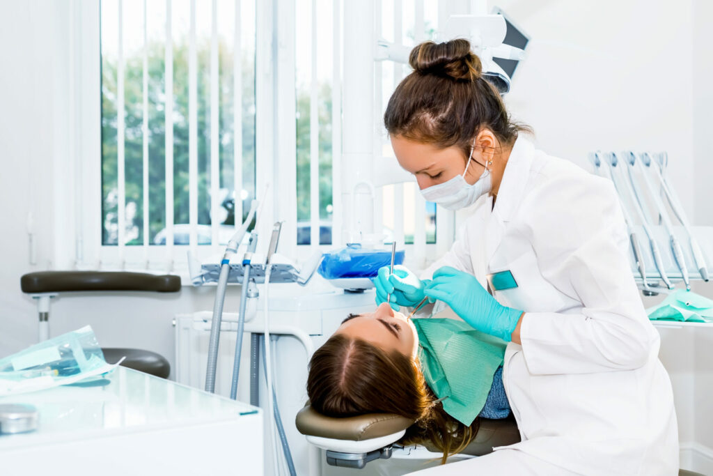 dentist checking patient's teeth