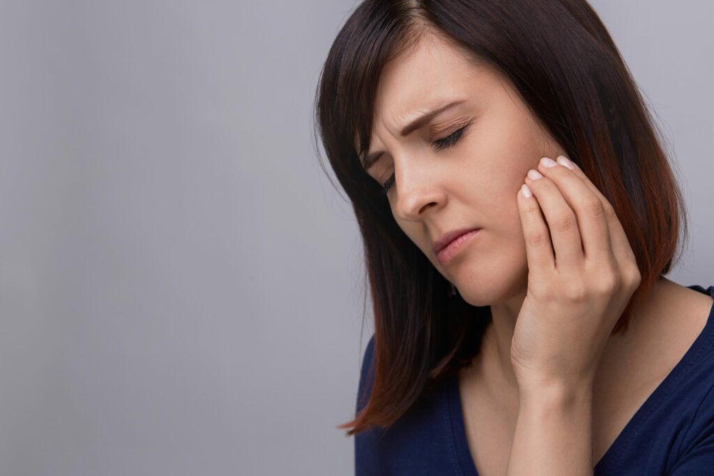 woman clutching jaw